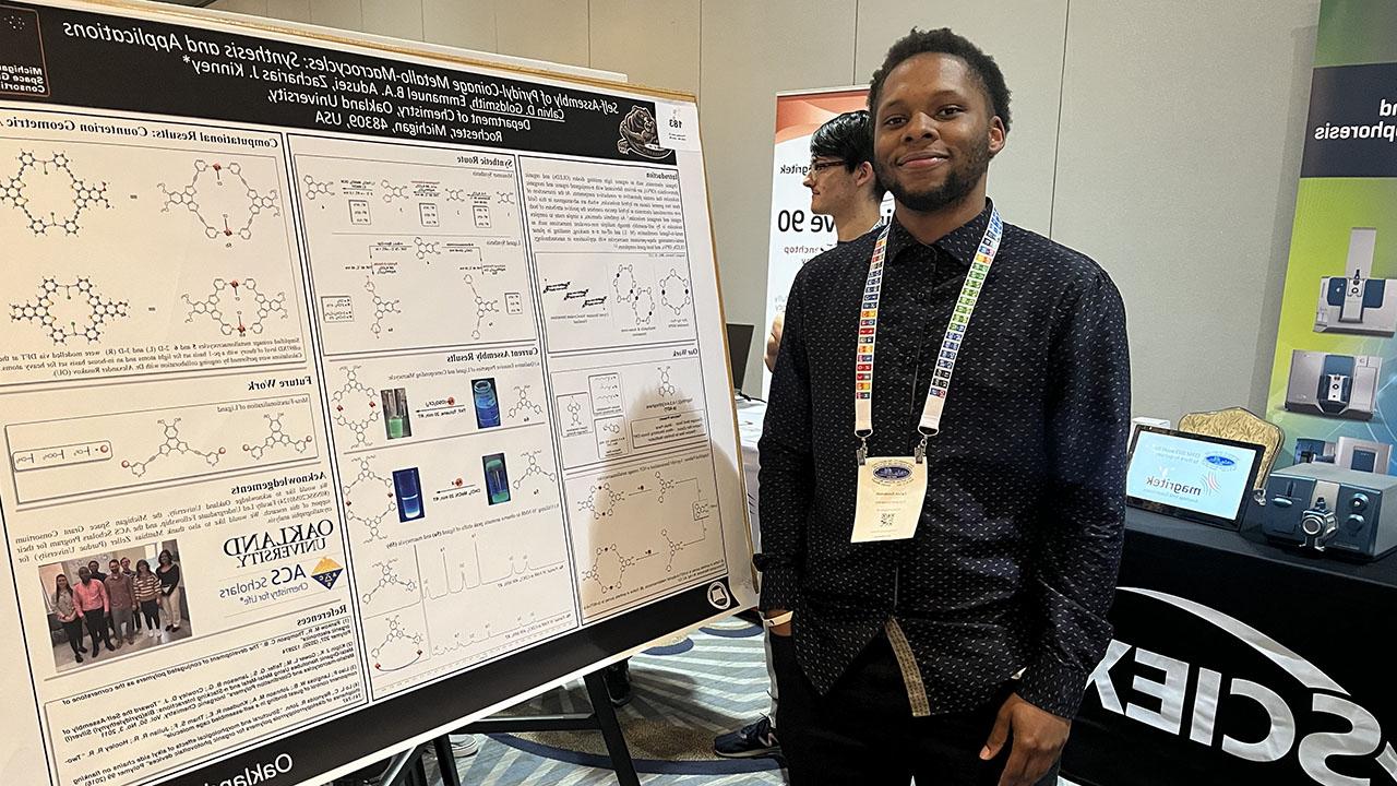 Calvin Goldsmith stands next to his research post.