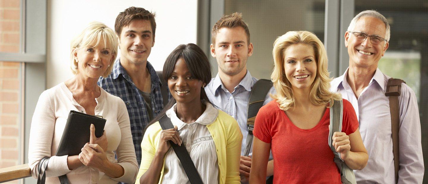 group of adults posing for a photo, smiling at the camera